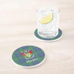 two coasters with the name murphy on them and a glass of water next to it