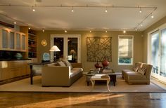 a living room with two couches, chairs and a coffee table in front of a window