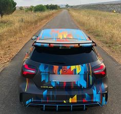 the back end of a car with graffiti painted on it