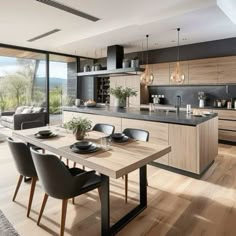 an open kitchen and dining area with wood flooring, black counter tops and chairs