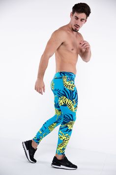 Description: Blue & Green Tiger Print Men’s Performance Leggings Compression Level: Light to Medium Sweat-wicking Poly / Spandex with 4-Way Stretch Bounce-Proof Phone Pocket Zip Pocket For Cash & Keys Ergonomic Waistband Adjustable Drawstring Flat Seams Sports Gusset Embroidered Bolt Logo Machine wash cold, quick drying Model is 6’2’’ (189cm) tall, 34’’ (86cm) waist size and wears size Large. Blue Fitted Bottoms For Running, Blue Sportswear Pants For Running, High Stretch Blue Running Bottoms, High Stretch Blue Bottoms For Running, Casual Blue Running Pants, Blue Elastane Sportswear Pants, Blue Elastane Training Pants, Casual Blue Leggings For Running, Blue Tight Sportswear Bottoms