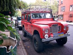 a red truck is parked on the side of the road