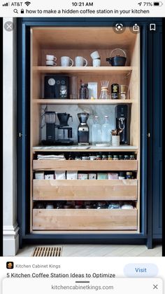 an open cabinet filled with coffee cups and other kitchen items on top of wooden shelves