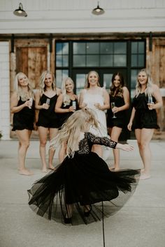 a group of young women standing around each other