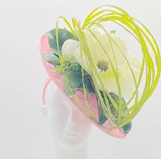 Handmade by Featured Milliner of The Kentucky Derby Museum 2023 & 2024! Dramatic & Classy: Pink & green magnolia fascinator with lime sprigs & succulent. A southern staple with movement and flare Attaches with headband. Work of art on your head! This piece proudly ranks in the Platinum Collection by Derbyologie...using elaborate materials and traditional, time-intensive millinery technique. The product? The finest of the fine in Derby fashion. Only 1 produced each season. Not taking customs this Luxury Green Headpiece For Kentucky Derby, Green Top Hat For Spring Races, Adjustable Green Top Hat For Spring, Green Hats For Spring Garden Party, Green Hat For Spring Garden Party, Green Hat For Garden Party In Spring, Green Mini Hat With Short Brim For Spring, Magnolia Leaf, Derby Fashion