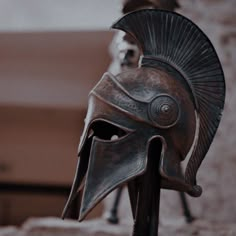 an ancient roman helmet on display in front of a building