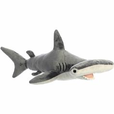 a stuffed shark is in the air with its mouth open