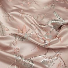 an image of a pink and silver fabric with flowers on the bottom half of it