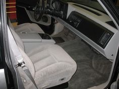 the interior of a car with white cloths on the floor and dash board area