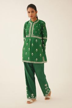 Green short kurta with silk thread embroidery in floral pattern and round neckline. Paired with straight pant.
Components: 2
Pattern: Embroidery
Type Of Work: Thread, floral
Neckline: Round
Sleeve Type: Three quarter
Fabric: Silk Chanderi
Color: Green
Other Details: 
Lined
Embroidery on pant hem
Elasticated waist at the back
Side pockets
Closure: Pant: Drawstring
Occasion: Work - Aza Fashions Traditional Kurta With Floral Embroidery And Straight Pants, Traditional Silk Pant Set With Resham Embroidery, Traditional Fitted Pant Set With Floral Embroidery, Traditional Embroidered Designer Pant Set, Traditional Straight Pant Set For Diwali, Traditional Silk Pant Set With Chikankari Embroidery, Traditional Pant Set With Intricate Embroidery For Designer Wear, Traditional Embroidered Straight Pant Set, Traditional Embroidered Sets With Straight Pants