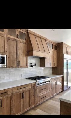 a kitchen with wooden cabinets and white counter tops is shown in an instagramtion