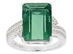 Pre-Owned 8.20ct emerald cut teal fluorite with .28ctw round white zircon, rhodium over sterling silver bypass ring. Measures approximately .84"L x .59"W. Not sizeable..  This product may be a customer return, vendor sample, or on-air display and is not in its originally manufactured condition.  It may not be new.  In some instances, these items are repackaged by JTV. Modern Green Jewelry With Prong Setting, Classic Jewelry With May Birthstone Gemstone Accents, Elegant Emerald Gemstones With Accent Stones, Modern Emerald Jewelry With Center Stone, Formal Emerald Gemstones With Accents, Elegant Faceted Emerald Gemstones, Emerald Gemstones With Accents For Anniversary, Formal Emerald Ring With Gemstone Accents, Elegant Green Topaz Ring In Sterling Silver