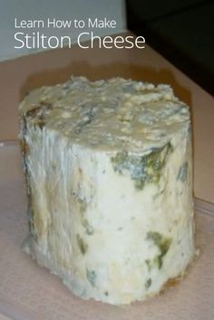 a piece of cheese sitting on top of a plastic container with the words learn how to make stilton cheese