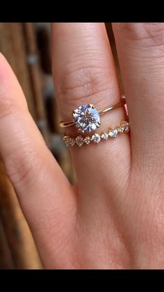 a woman's hand with a ring on it and a diamond in the middle