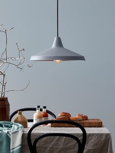 a table with some food on it and a light hanging over it