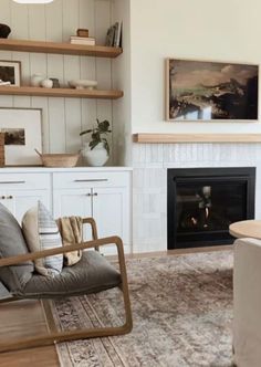 a living room filled with furniture and a fire place in the middle of the room