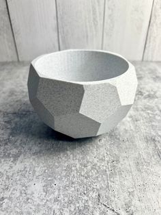 a white bowl sitting on top of a wooden table