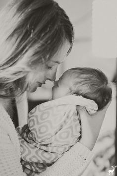 a woman holding a baby in her arms