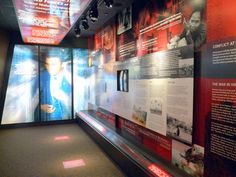 an exhibit room with posters and lights on the wall, along with other information about men's lives