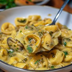 a bowl filled with pasta covered in sauce