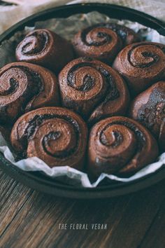 chocolate cinnamon rolls in a bowl on a wooden table