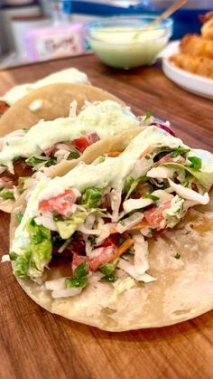 two tacos sitting on top of a wooden table