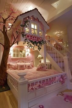 a dollhouse bed in the shape of a tree with pink flowers and leaves on it