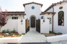 a white house with brown doors and windows