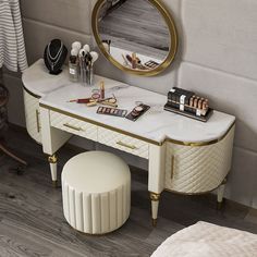 a vanity with a mirror, makeup and other items on it next to a stool