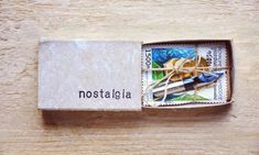 a matchbox with an image of a bird in the woods on it's side