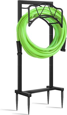 a green hose is attached to a black stand