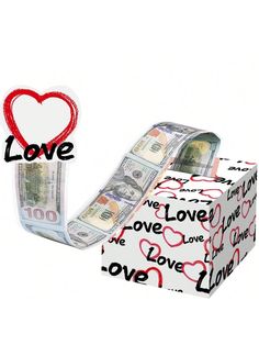 a roll of money sitting on top of a box with the word love written on it