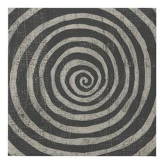 a black and white rug with an abstract spiral design on the front, in shades of grey