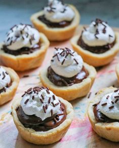 small desserts with chocolate and whipped cream on them