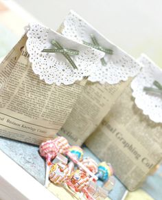 two small pieces of paper with lace on them sitting next to each other, one folded up and the other closed