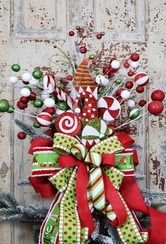 a green and red christmas wreath with candy canes