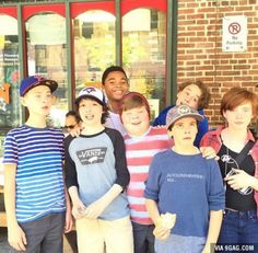 a group of children standing in front of a store