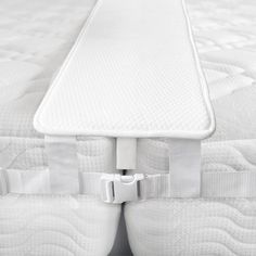 the mattress is attached to the side of the bed with two straps on each side