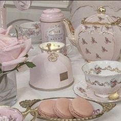 there is a pink tea set on the table