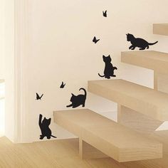 the cat wall stickers are on the stairs in this room, and it looks like they're falling off