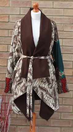 A unique three African  print  jacket. This stylish jacket is loose fitting, fully lined to keep you warm  and very comfortable Jacket has no closure( Belt included), big  raglan long sleeves and waterfall collar.  Available in  5 sizes SMALL- (8-10) uk sizes MEDIUM- (12-14) LARGE (16-18) X-LARGE (20-22) XX-LARGE (24-26) Can be made in other prints please enquire to see what prints we have in stock. Ankara Jacket Styles, African Print Coat, African Print Jacket, Kenya Fashion, Nigerian Fashion Ankara, Ankara Jackets, Dress Ankara, African Print Dress Ankara, Ghanaian Fashion