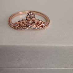 a diamond ring sitting on top of a white box with a heart in the middle