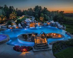 an outdoor swimming pool at night with steps leading up to it