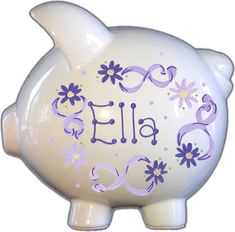 a white piggy bank with purple flowers and the word ella painted on it's side