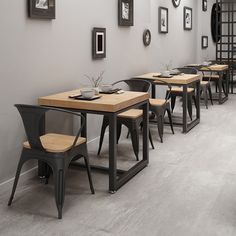 a restaurant with tables and chairs lined up against the wall, along with pictures on the walls