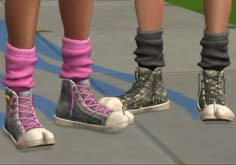 three pairs of shoes with pink socks and gray boots on the bottom are standing next to each other