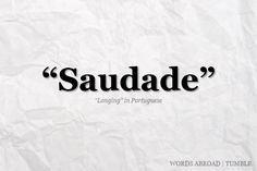 a piece of paper with the words saudade written on it in black ink