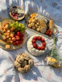 a table topped with lots of different types of food on plates and serving trays