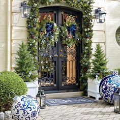 a front door decorated for christmas with wreaths and ornaments