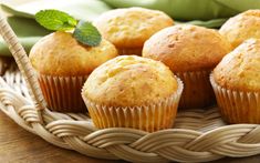 some muffins are sitting in a basket on a table